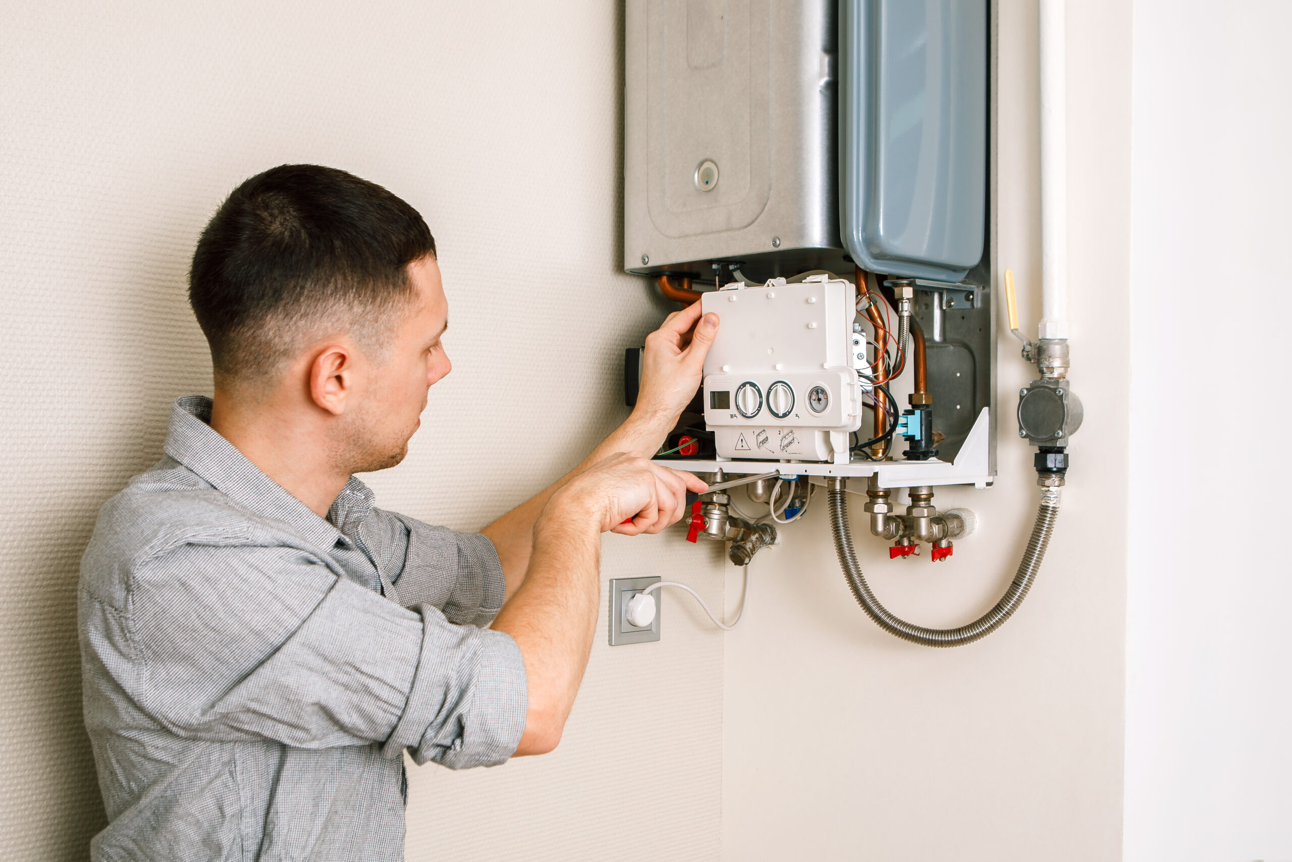 Technician repairing residential gas boiler