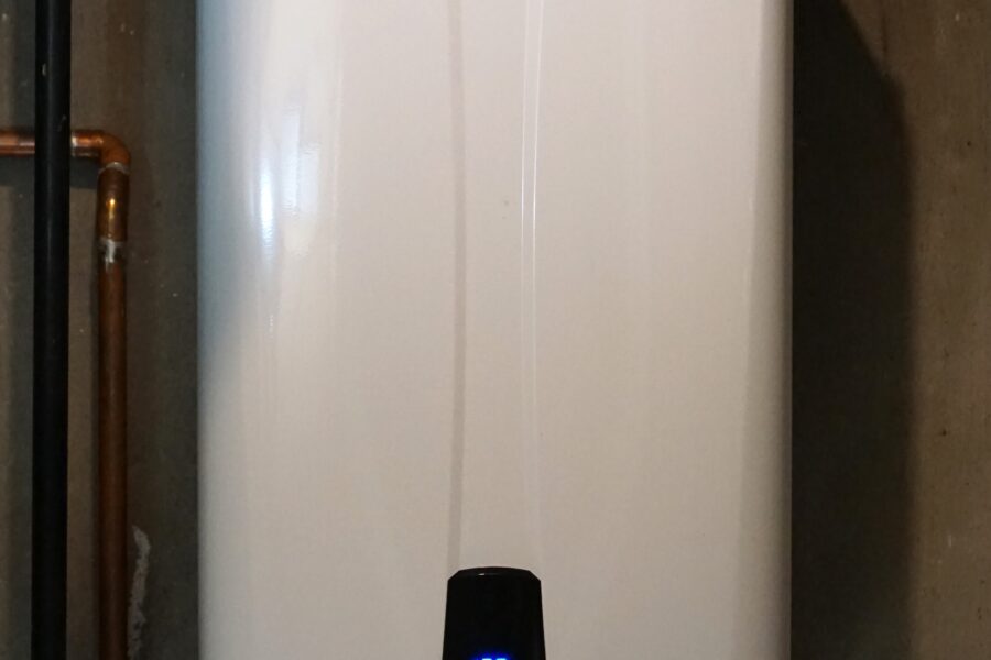 Modern tankless water heater installed with pipes