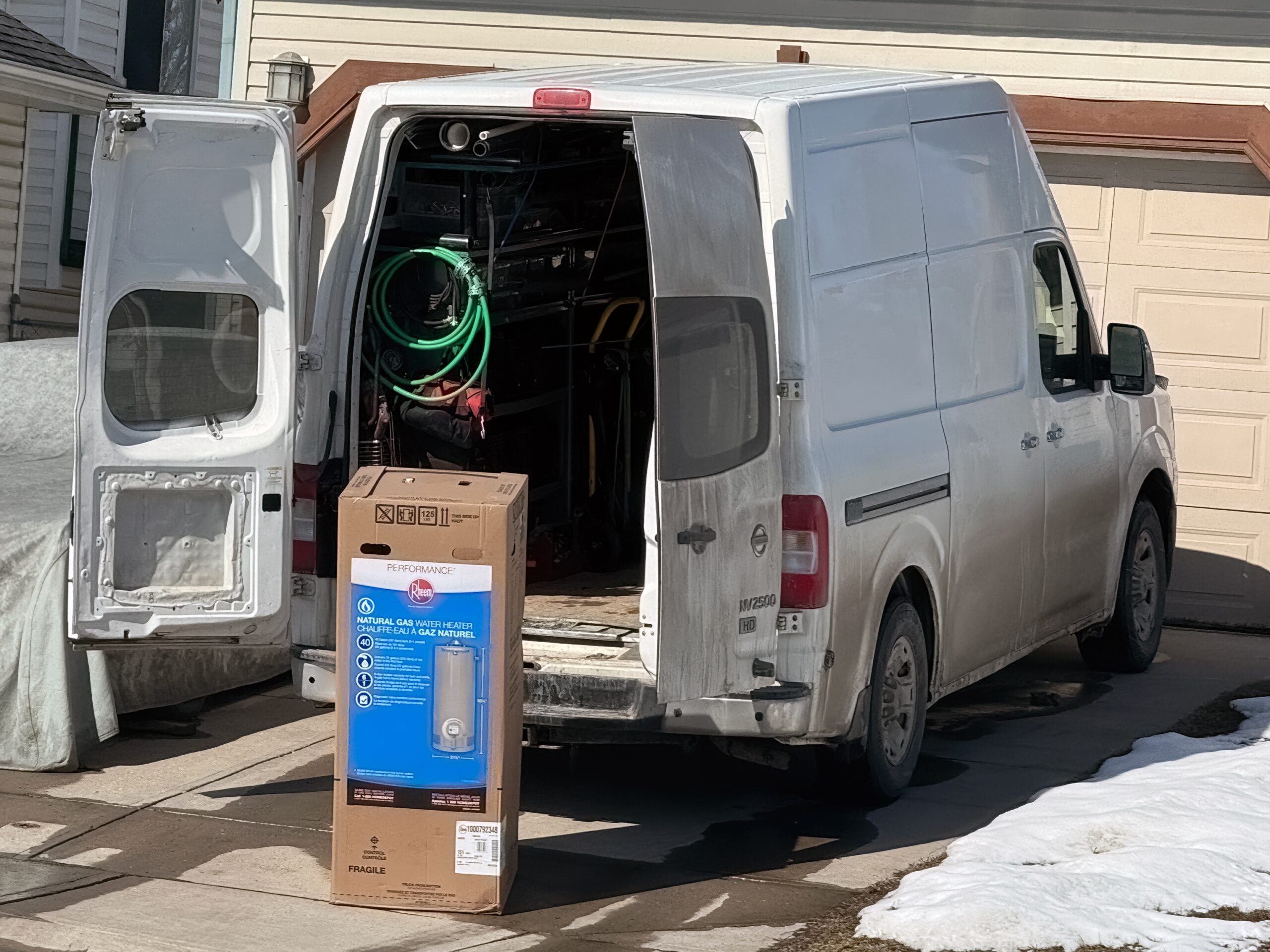 Service van with open doors and unpacked water heater